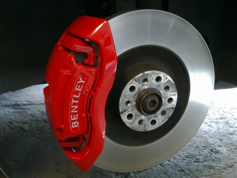 modified red brake caliper, painted for a Bentley